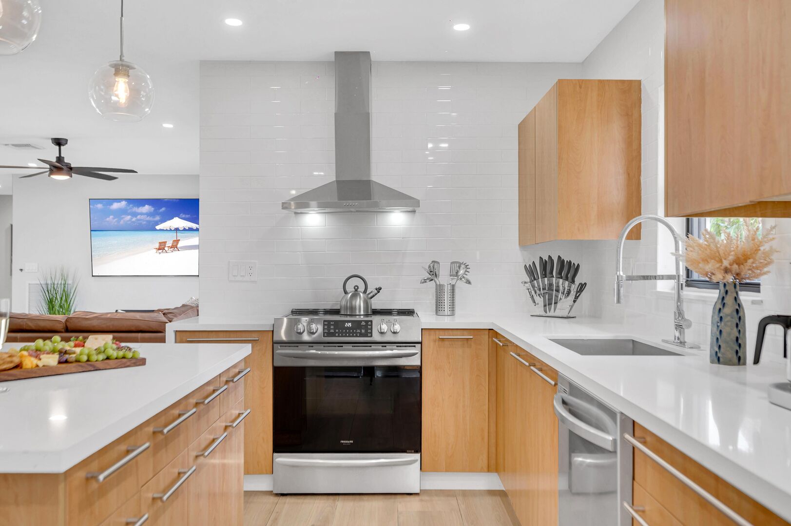 The kitchen comes with sleek countertops, modern appliances and bar seating for two people.