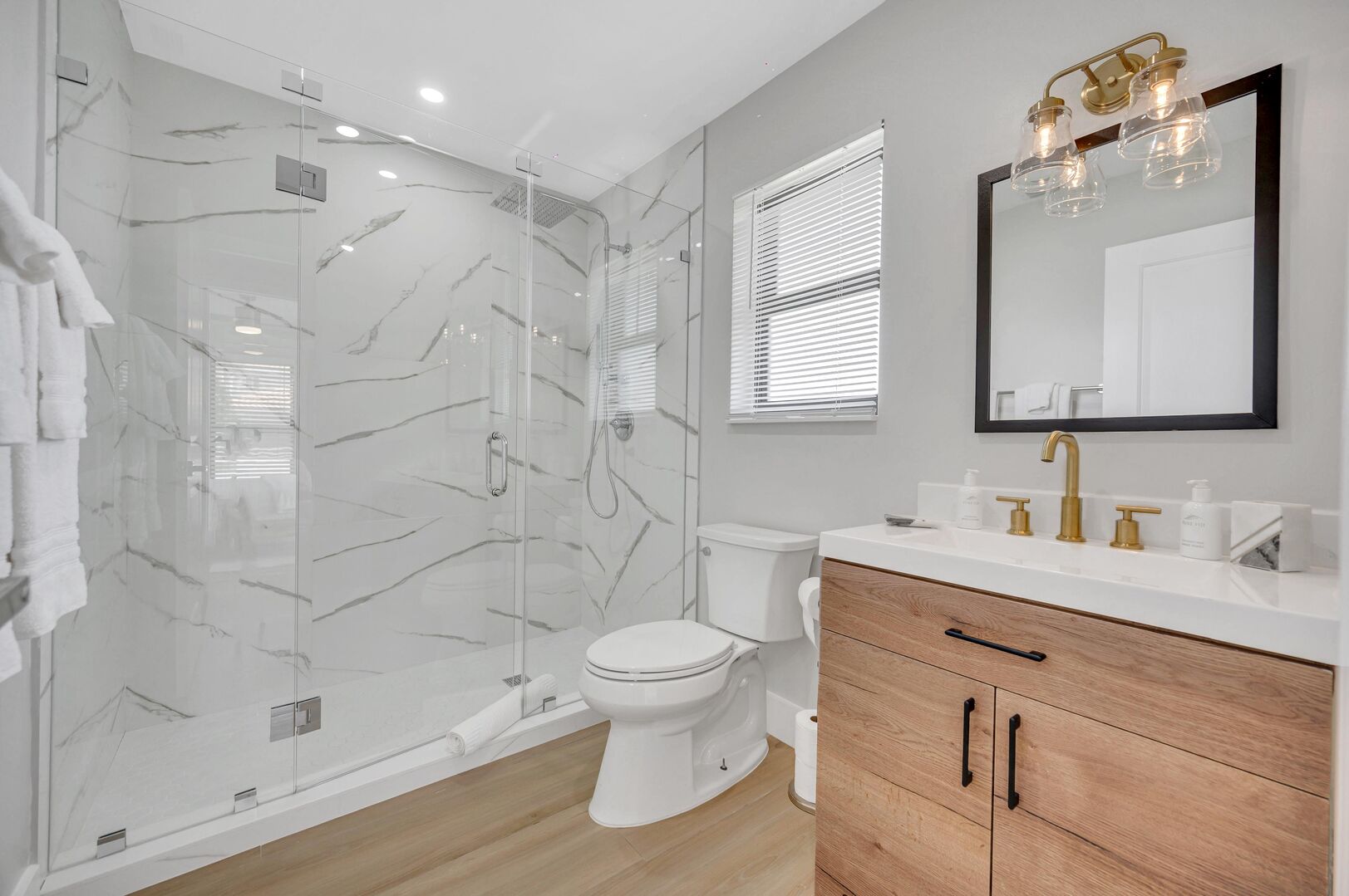The guest bathroom features a walk-in shower across from bedroom 3 & 4.