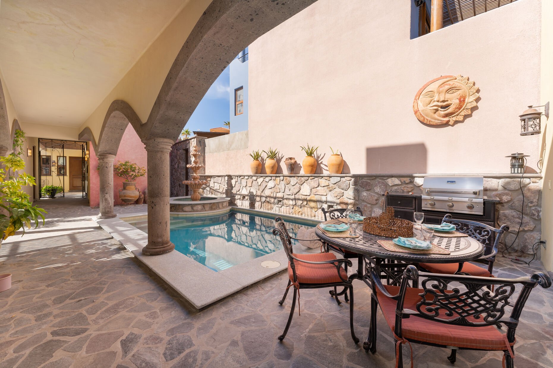 Pool courtyard with outdoor shower, fountain, BBQ area and outdoor dining