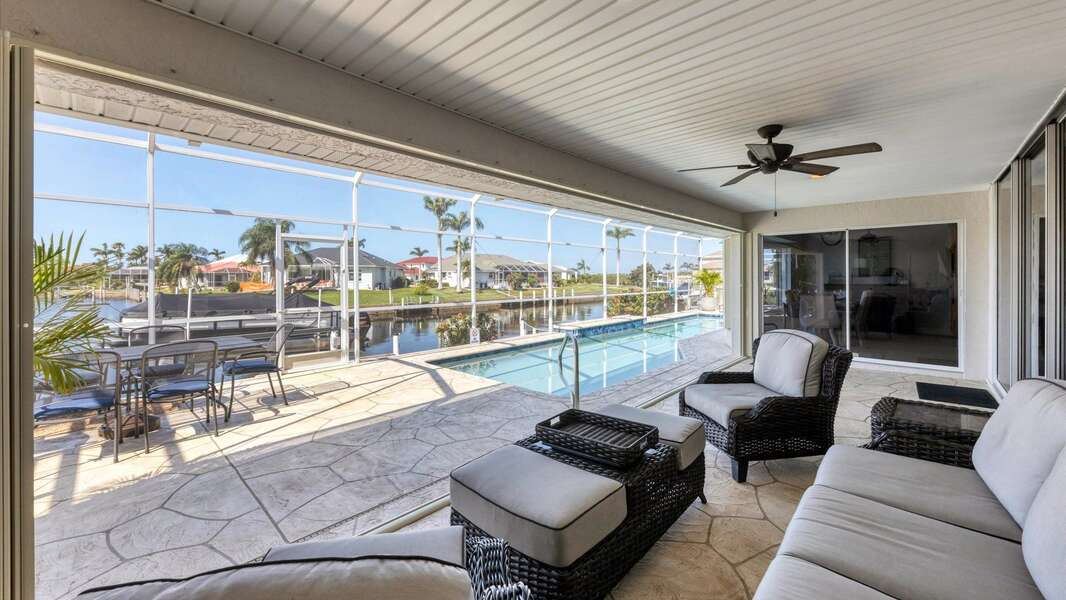Covered lanai seating overlooks the canal and pool