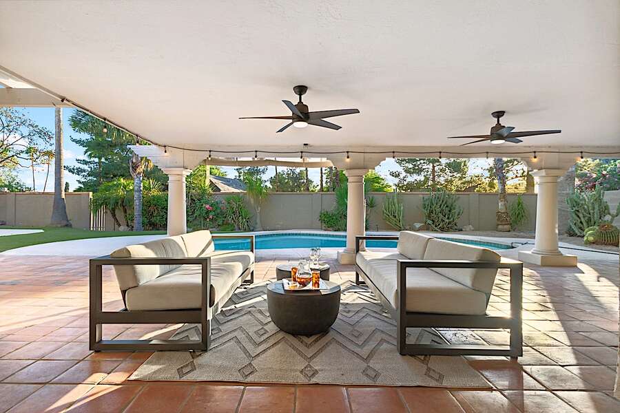 Outdoor sitting area w/ table and ceiling fans for a nice breeze