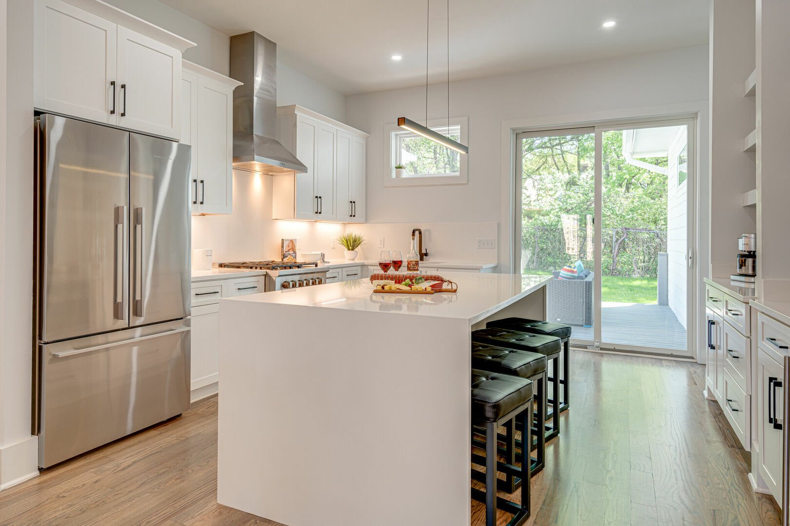 1st Floor: Gourmet style kitchen featuring all stainless steel appliances, coffee bar, wine fridge, breakfast bar, and formal dining area that seats 6.