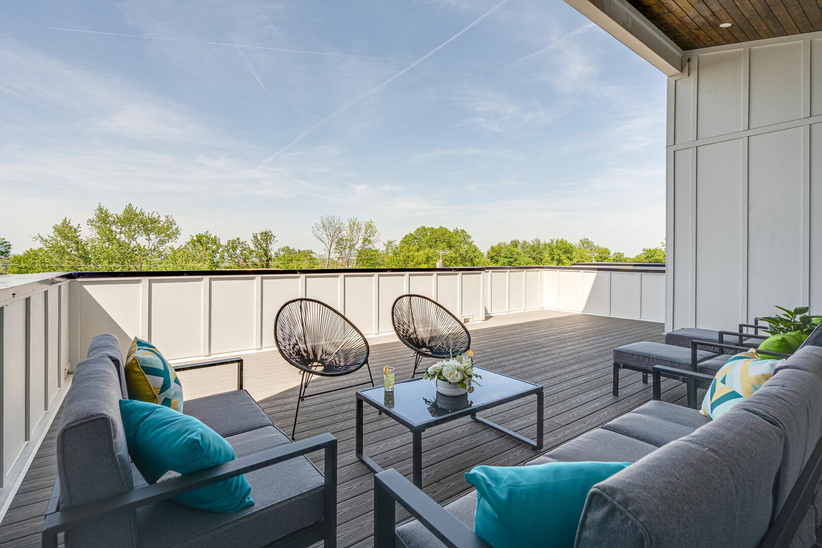 3rd Floor: Large private rooftop deck with multiple lounge areas that overlook the area and also includes sun loungers.
