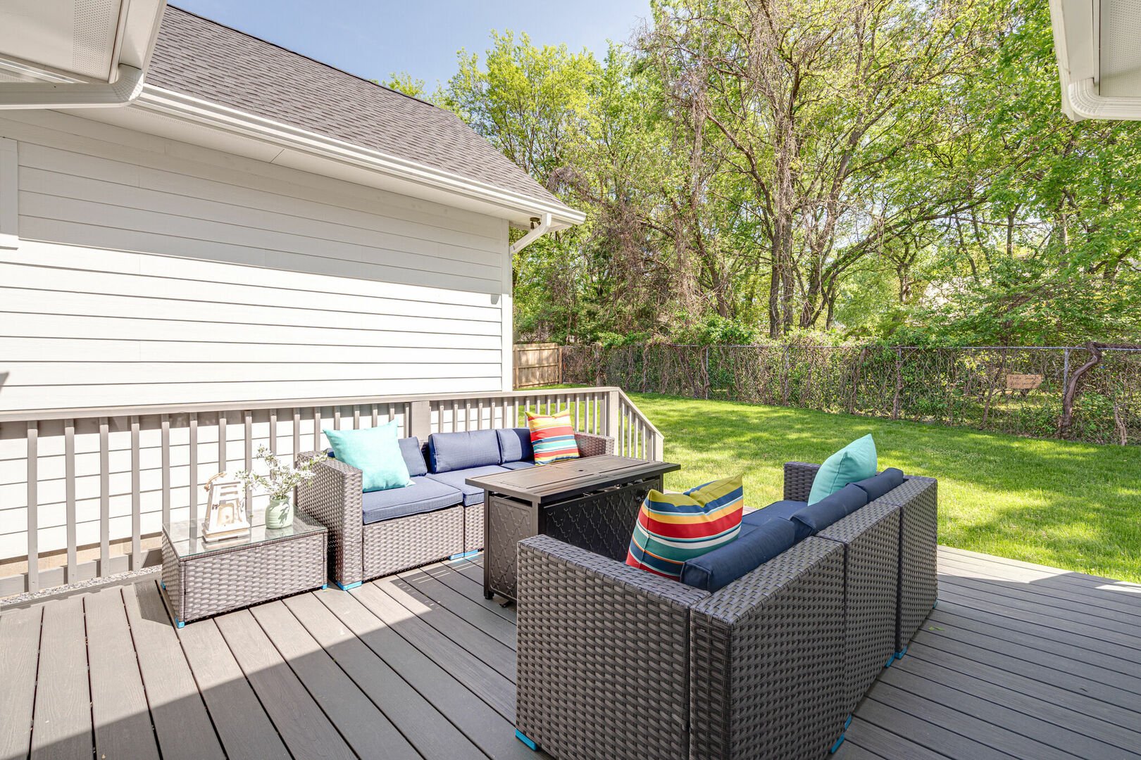 Private yard with patio. The patio includes a fire pit and a surrounding lounge area.