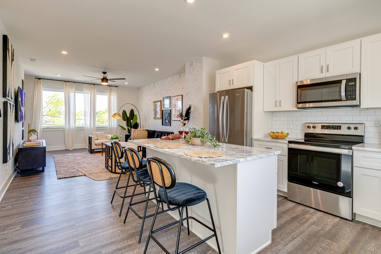 1st Unit, 2nd Floor: Open kitchen with stainless steel appliances, large island, breakfast bar seating, and is fully equipped with your basic cooking essentials.