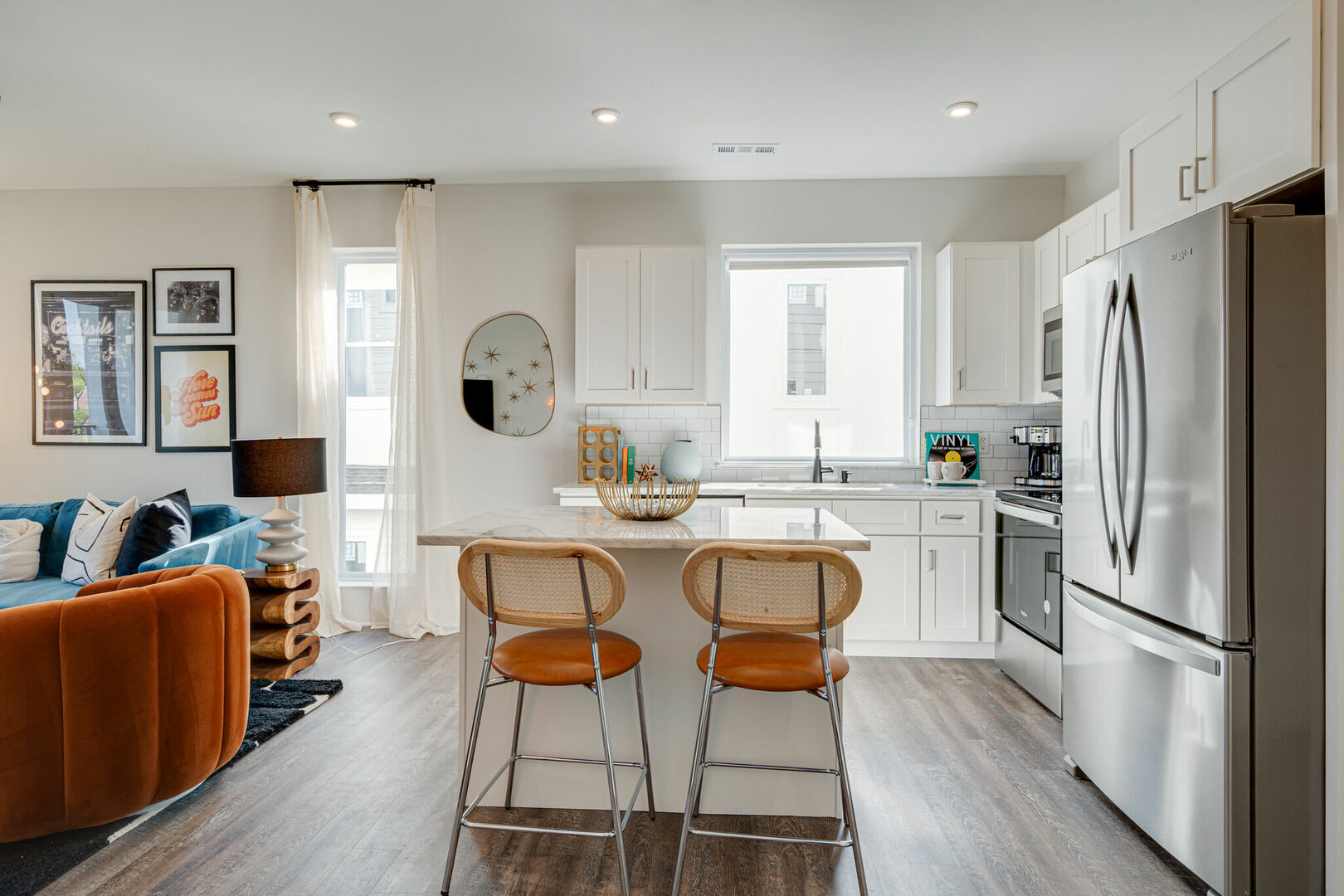 1st Unit, 2nd Floor: Bright and open kitchen equipped with stainless steel appliances and is fully stocked with your basic cooking essentials. Features breakfast bar seating and connects to living space.
