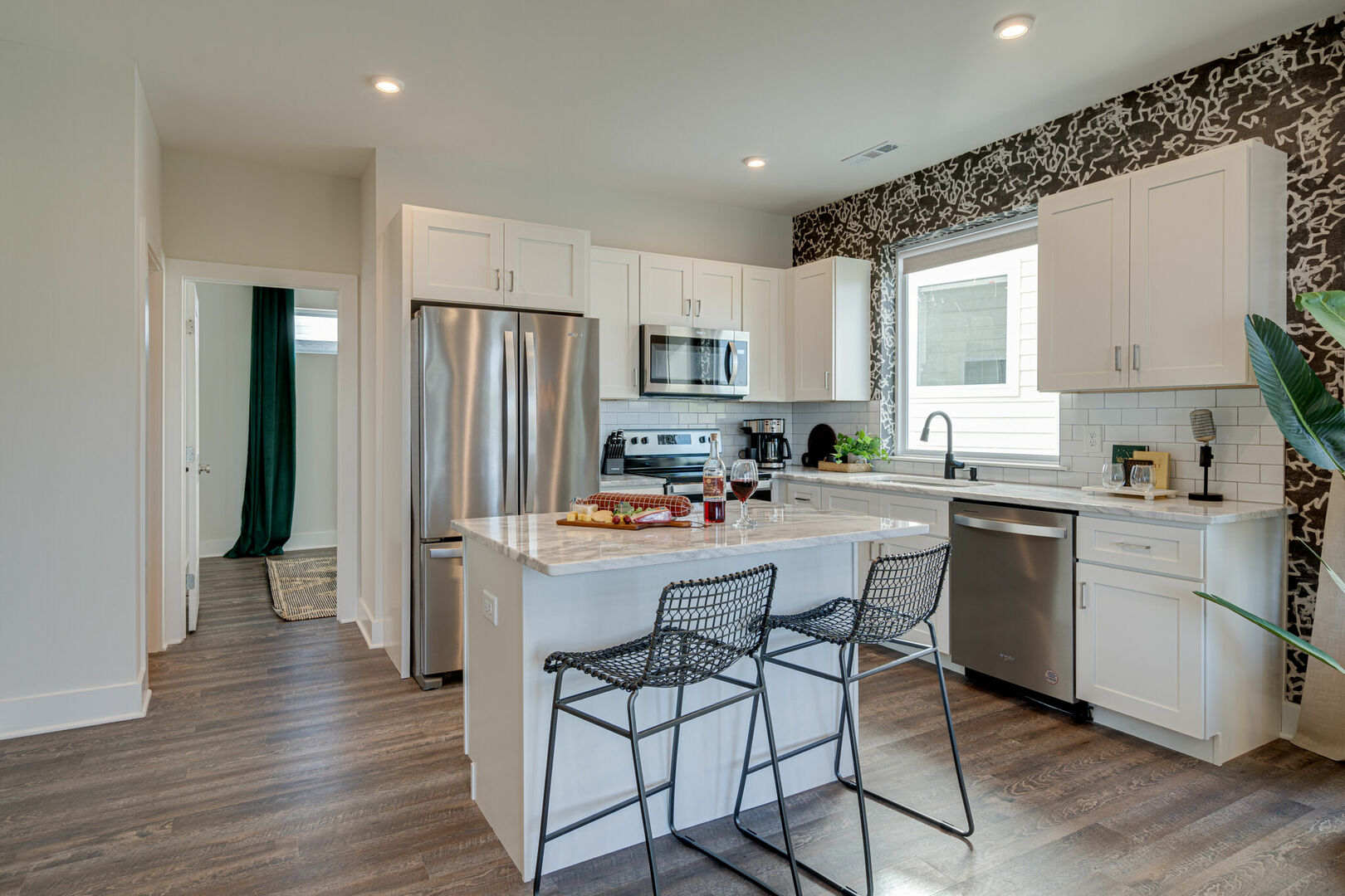 2nd Unit, 2nd Floor: Open kitchen with stainless steel appliances, large island, breakfast bar seating, and is fully equipped with your basic cooking essentials.
