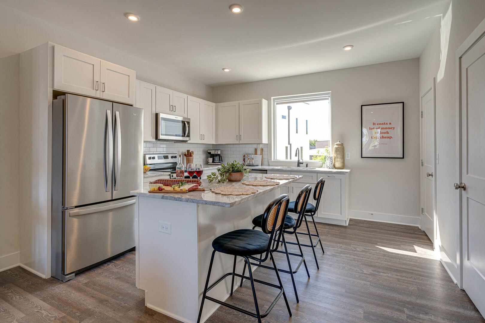 Open kitchen with stainless steel appliances, large island, breakfast bar seating, and is fully equipped with your basic cooking essentials. (2nd Floor) -Unit 2-