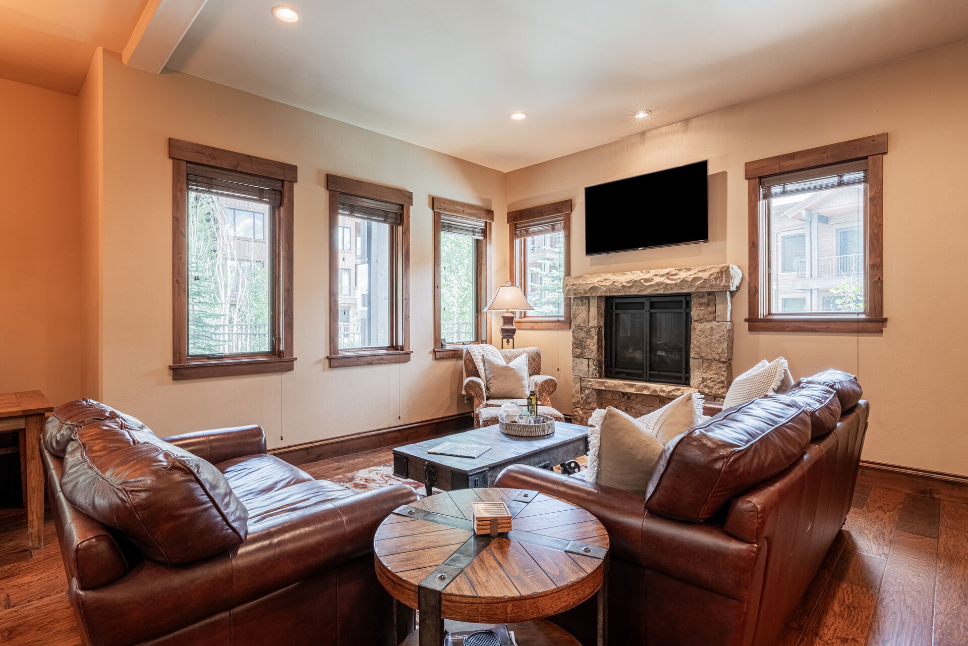 Leather sofas, arm chair, and stone fire place