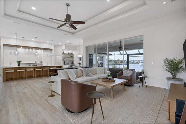 Gorgeous open living area with ample seating, 65-inch Smart TV & dining table that converts to a tavern shuffleboard table