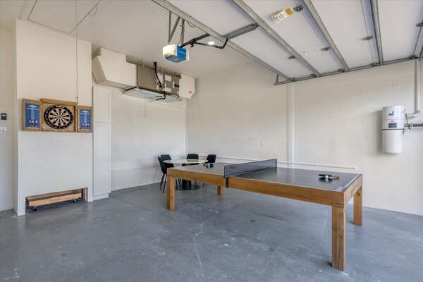 The game room in the garage has a ping pong table, a card table, and darts!