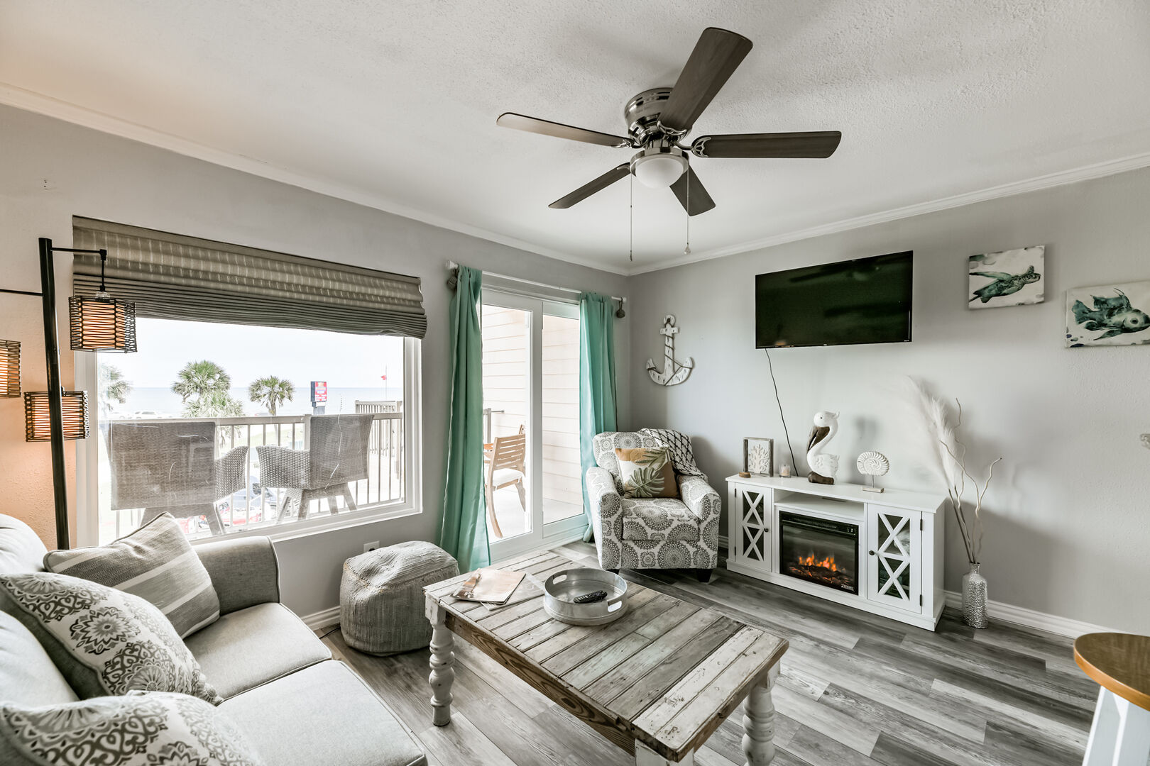 ENJOY COMFY SEATING AND WALL MOUNTED TV AT THE END OF A LONG DAY AT THE BEACH