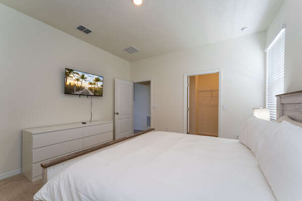 Master bedroom showing king bed and TV
