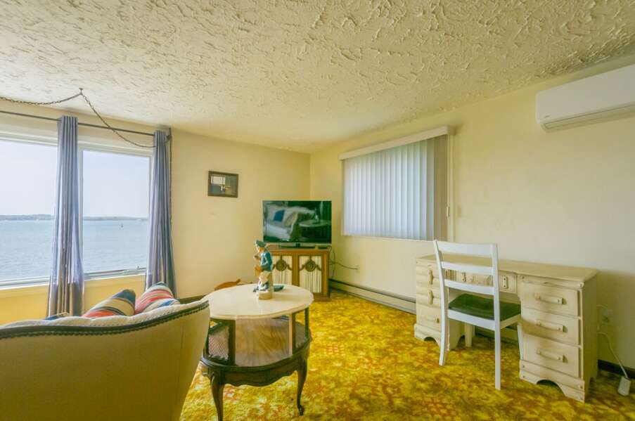 Upstairs Suite: Including a living room with ocean views from the large picture window, remote desk, TV, Kitchen, bathroom and Queen Bed.