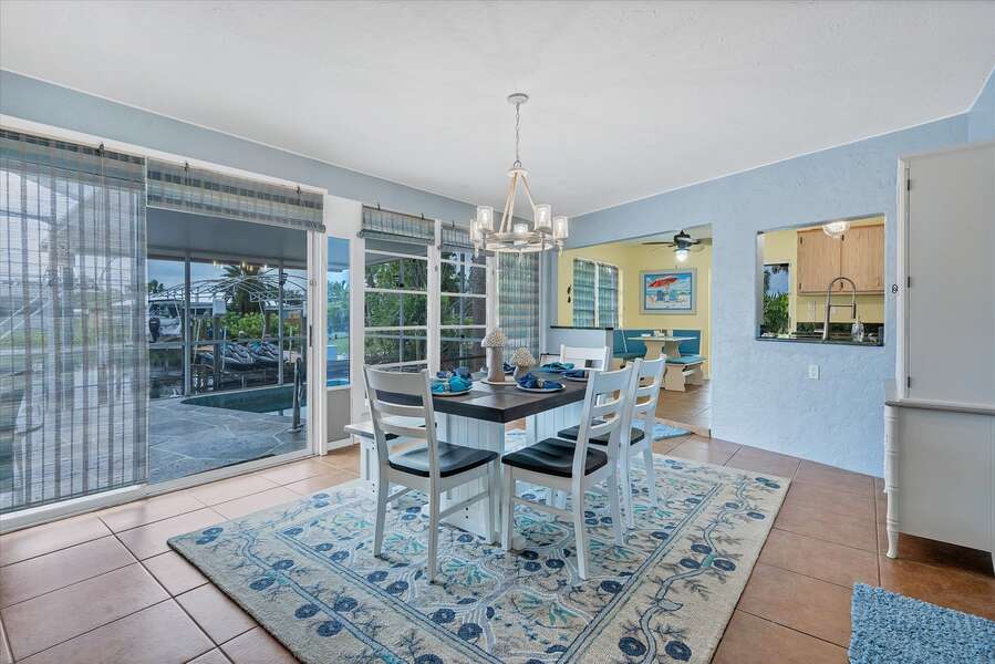 Bright and open dining room overlooks the canal and lanai