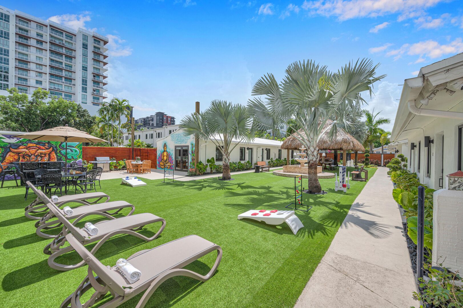 Suite Two is one of seven suites surrounding a garden that features wall murals, a tiki gazebo, a giant chess board, mini golf, a hot tub, a grill, as well as many lounging and dining areas.