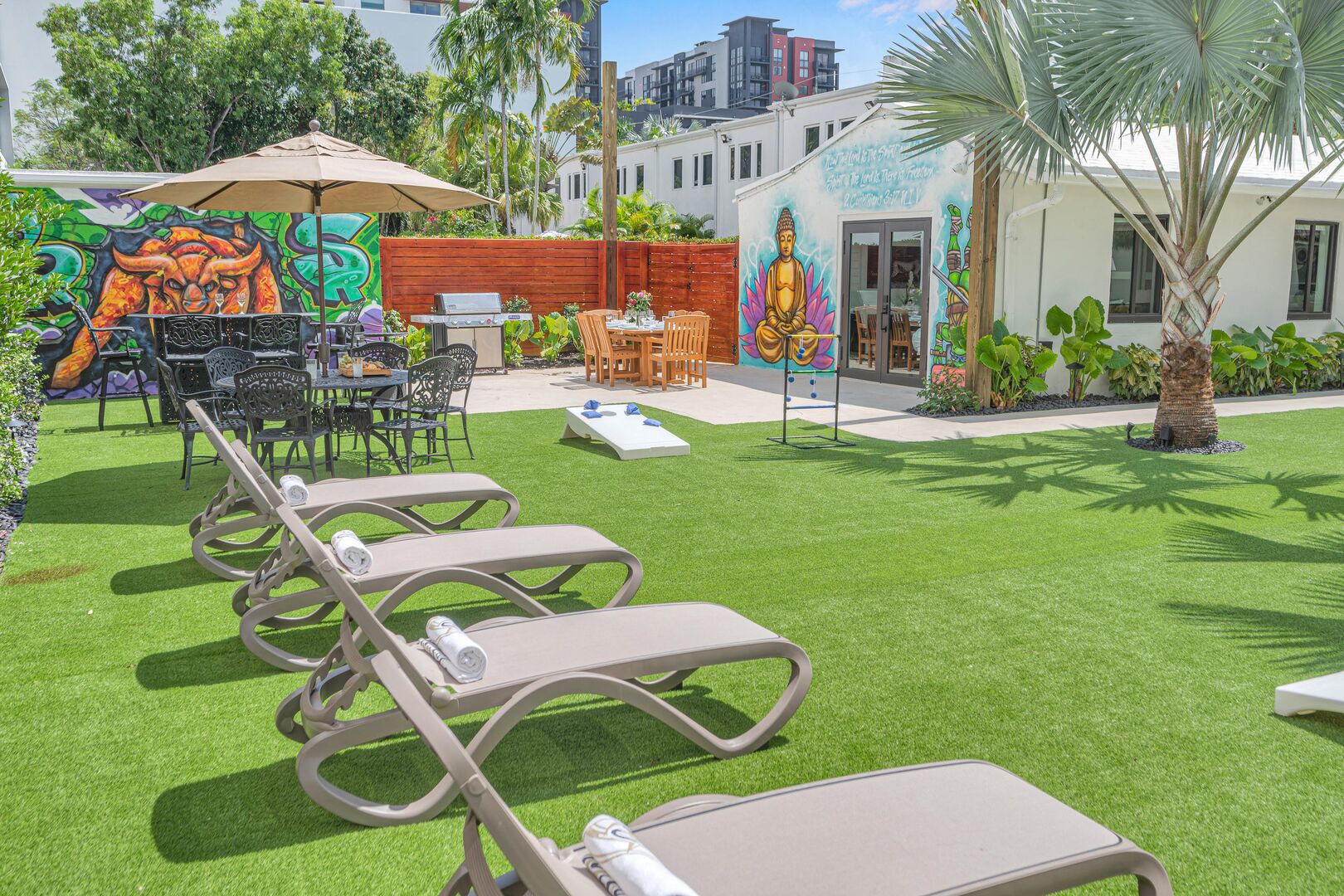 There are lounge chairs, an outdoor bar area, yard games, and a seating area by the grill!