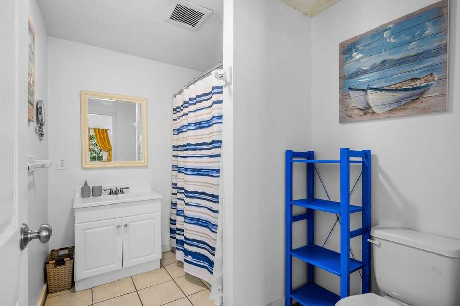 Bathroom #1 is full bathroom with tub/shower combination and coastal blue accents - 158 Riverside Drive West Harwich - Fleetwing - NEVR