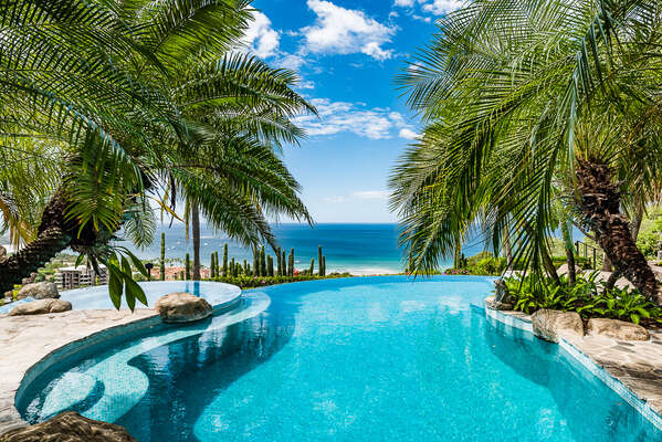 Dive into Luxury at our infinity pool overlooking the mesmerizing ocean