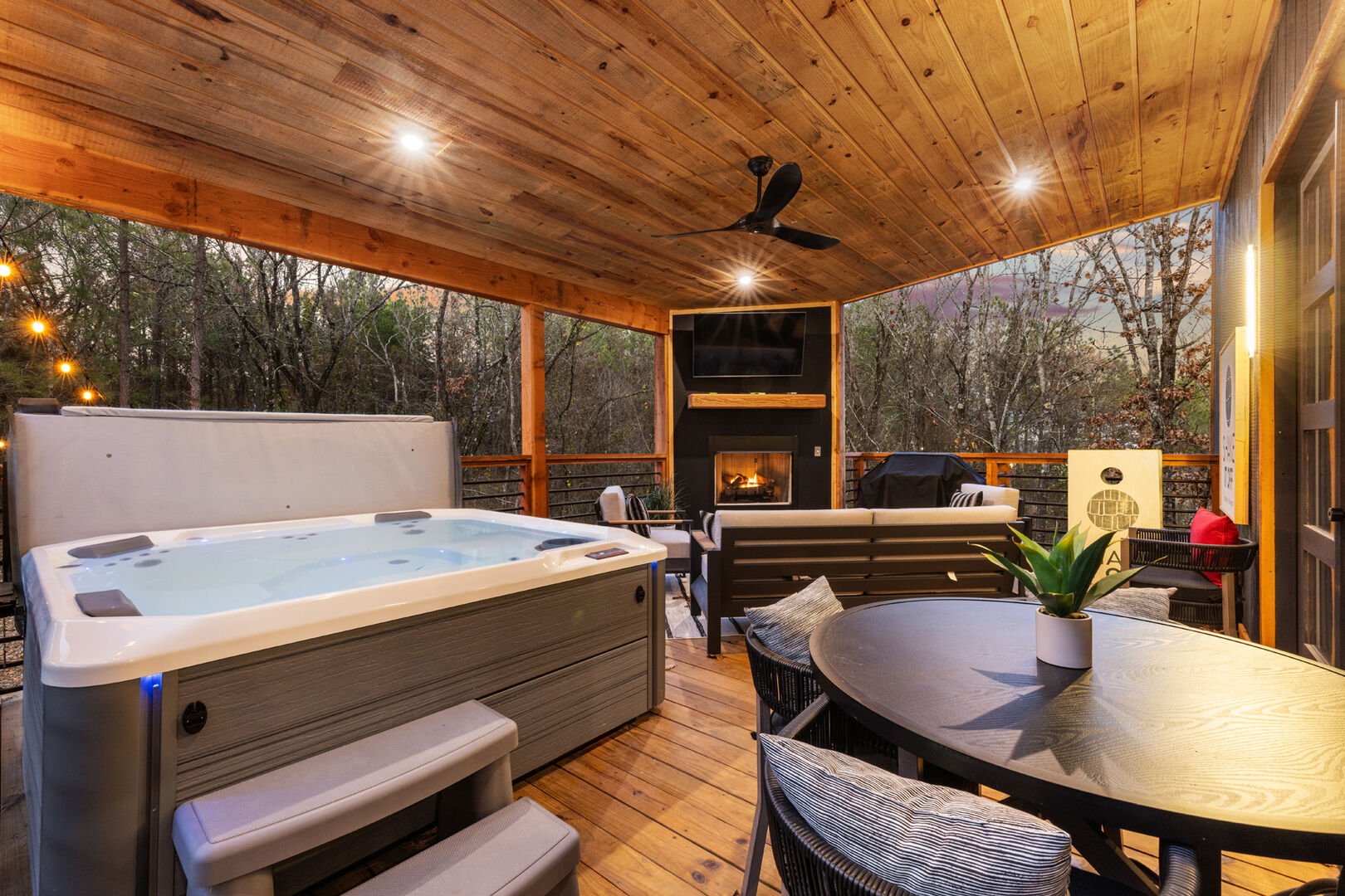 Outdoor patio area includes hot tub, gas fireplace and TV