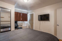 Master Bedroom Downstairs - Queen Bed , Smart Flat Screen TV, Shared Full Bathroom just outside bedroom door.