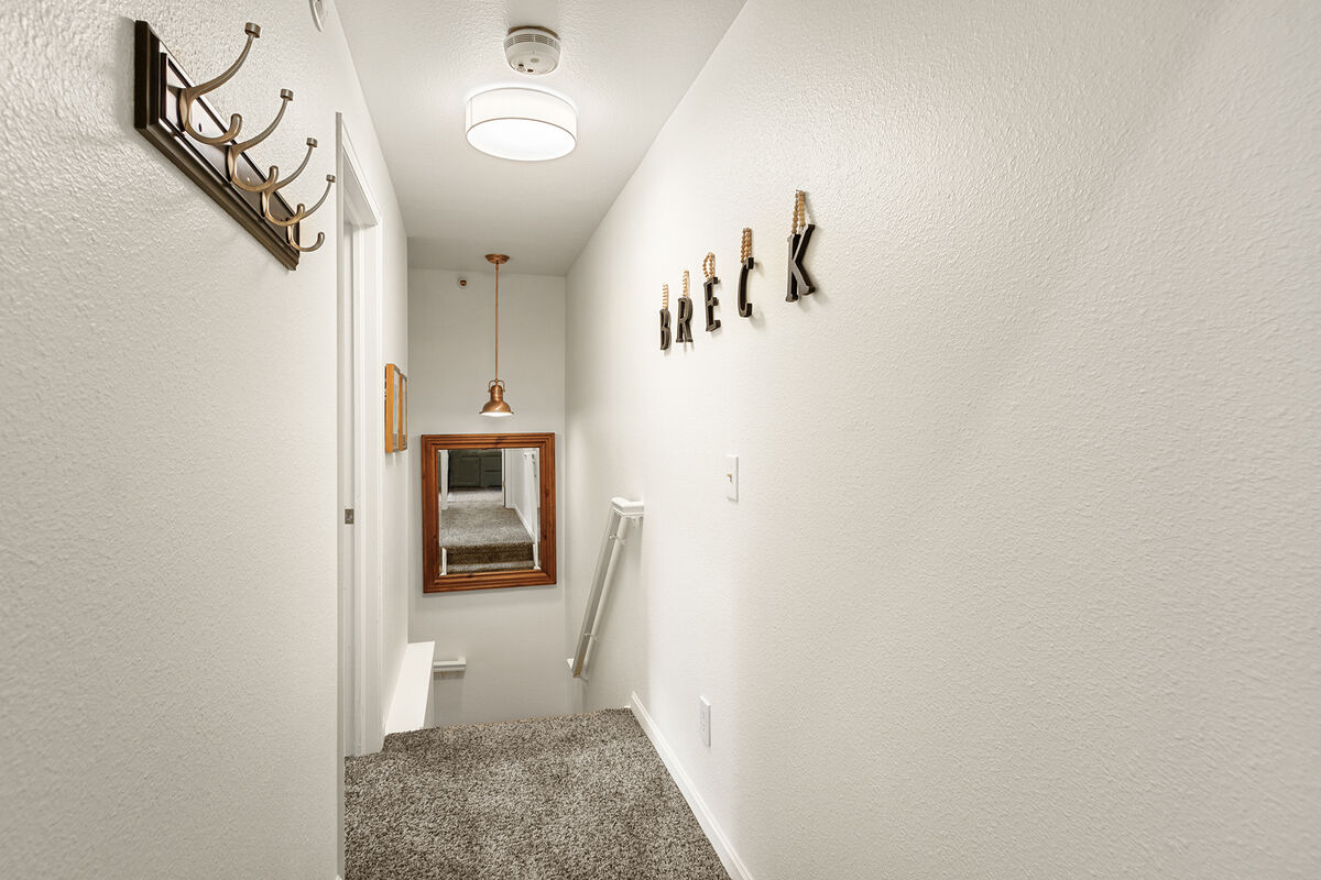 The upper hallway leading to the bedrooms. ➡️ Explore the inviting spaces of your home away from home.