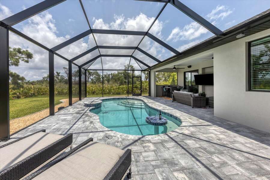 Expansive pool deck with lots of privacy surrounding the backyard