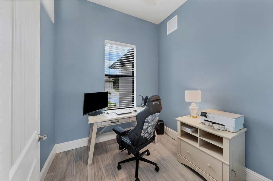 Dedicated office space with monitor and printer, desk and chair with door that will close and window for natural lighting