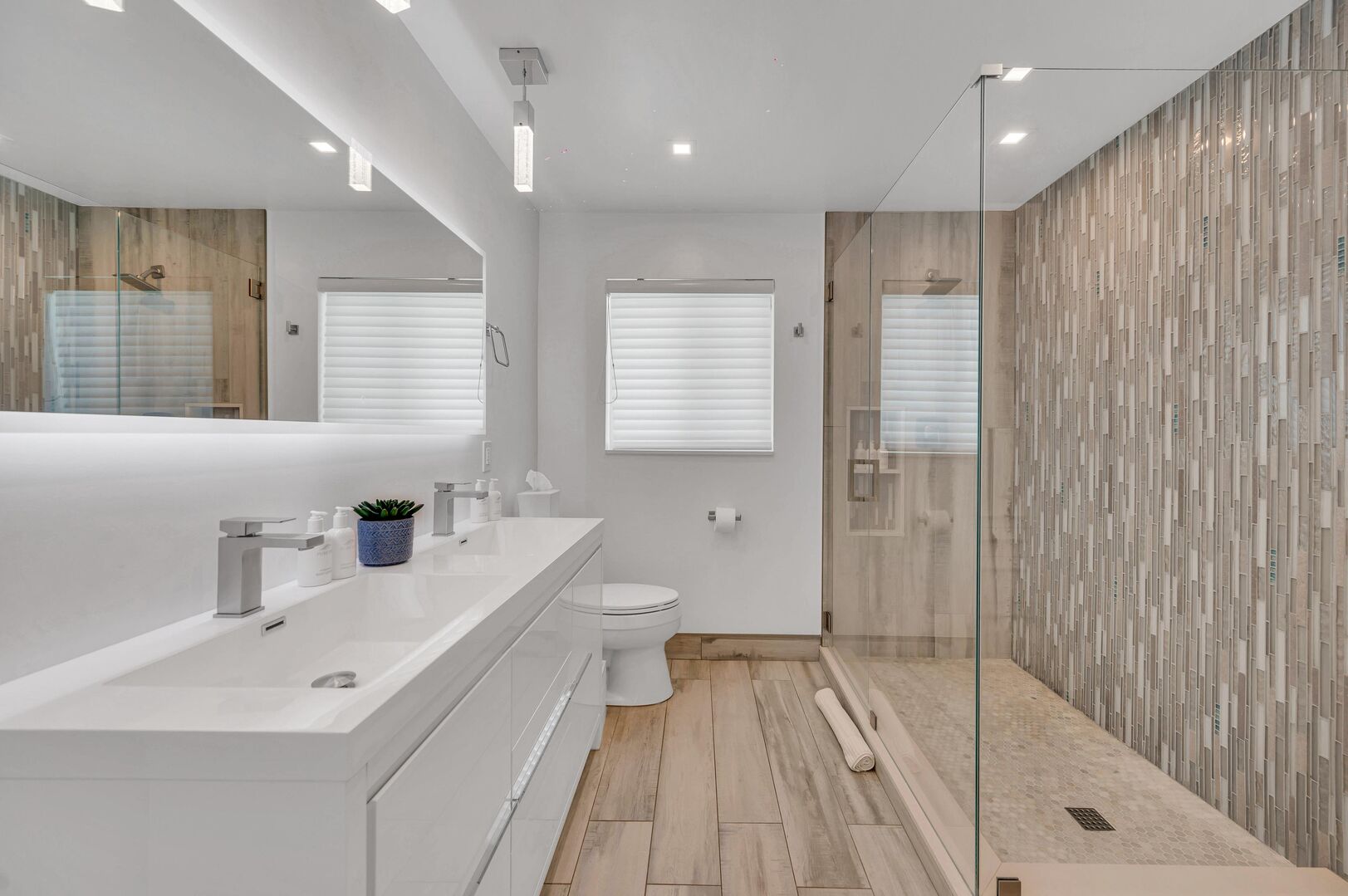 Indulge in a spa-like experience in our guest bathroom, where luxury meets functionality with a stunning walk-in shower and stylish double vanities.