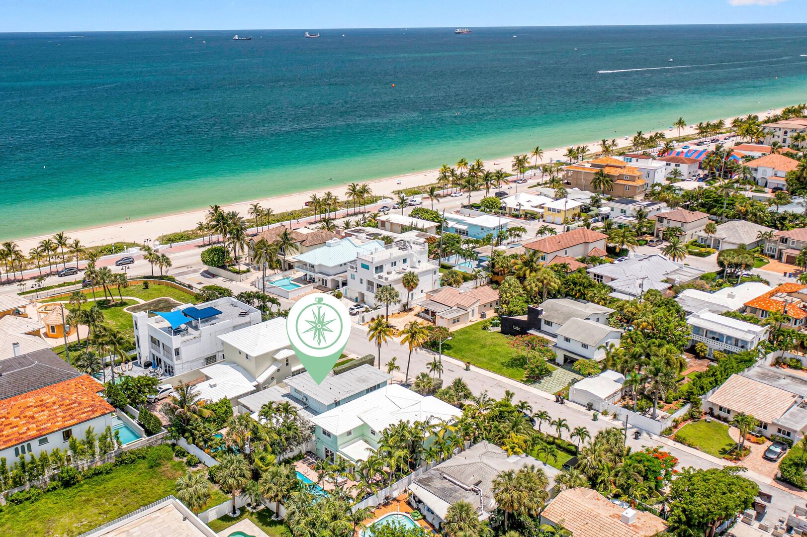 Discover paradise from above, where the ocean meets the horizon - a breathtaking aerial view of the pristine shoreline just a leisurely stroll away.