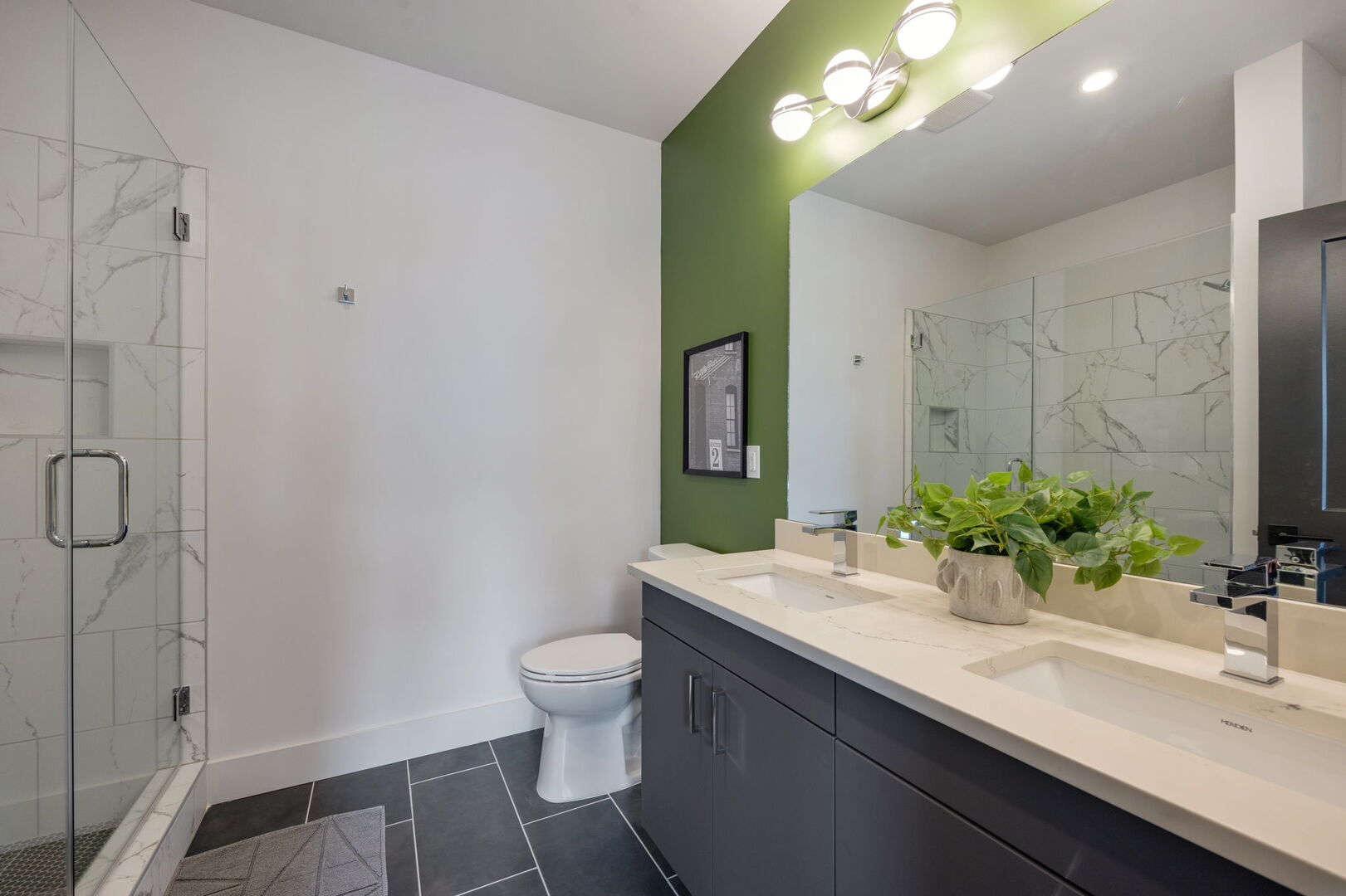 Primary Bathroom (Primary Bedroom en-suite) with dual vanities and stand-in shower.
