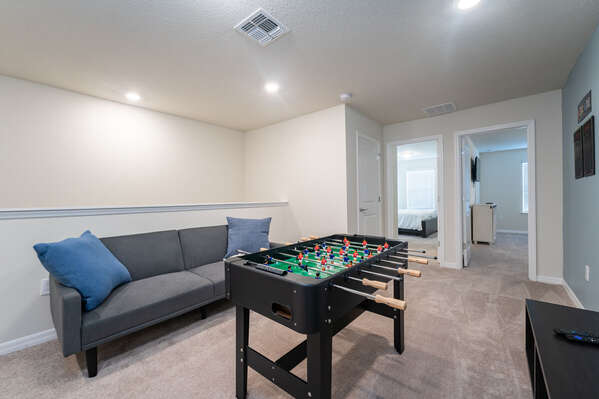 Upstairs loft has comfortable seating and foosball game