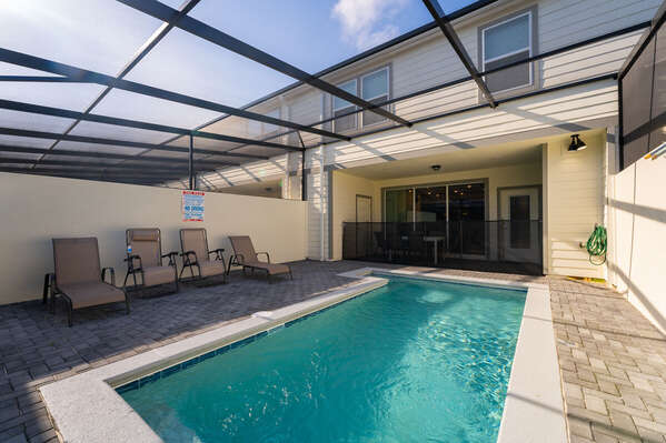 Fully screened in pool area with 2 sun loungers and 2 recliner chairs
