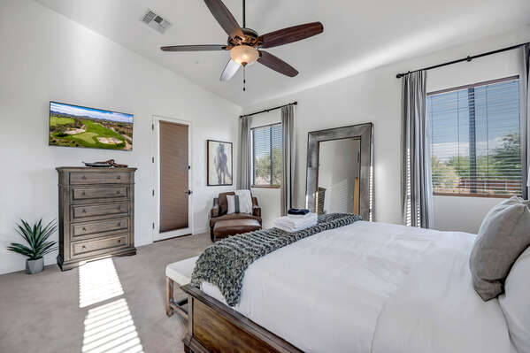 Master Bedroom with King Bed, Chaise Chair, Smart TV and Access to Backyard Space