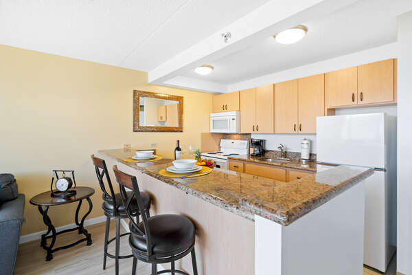 This unit has a full-equipped kitchen and a bar counter with 2 bar stools.