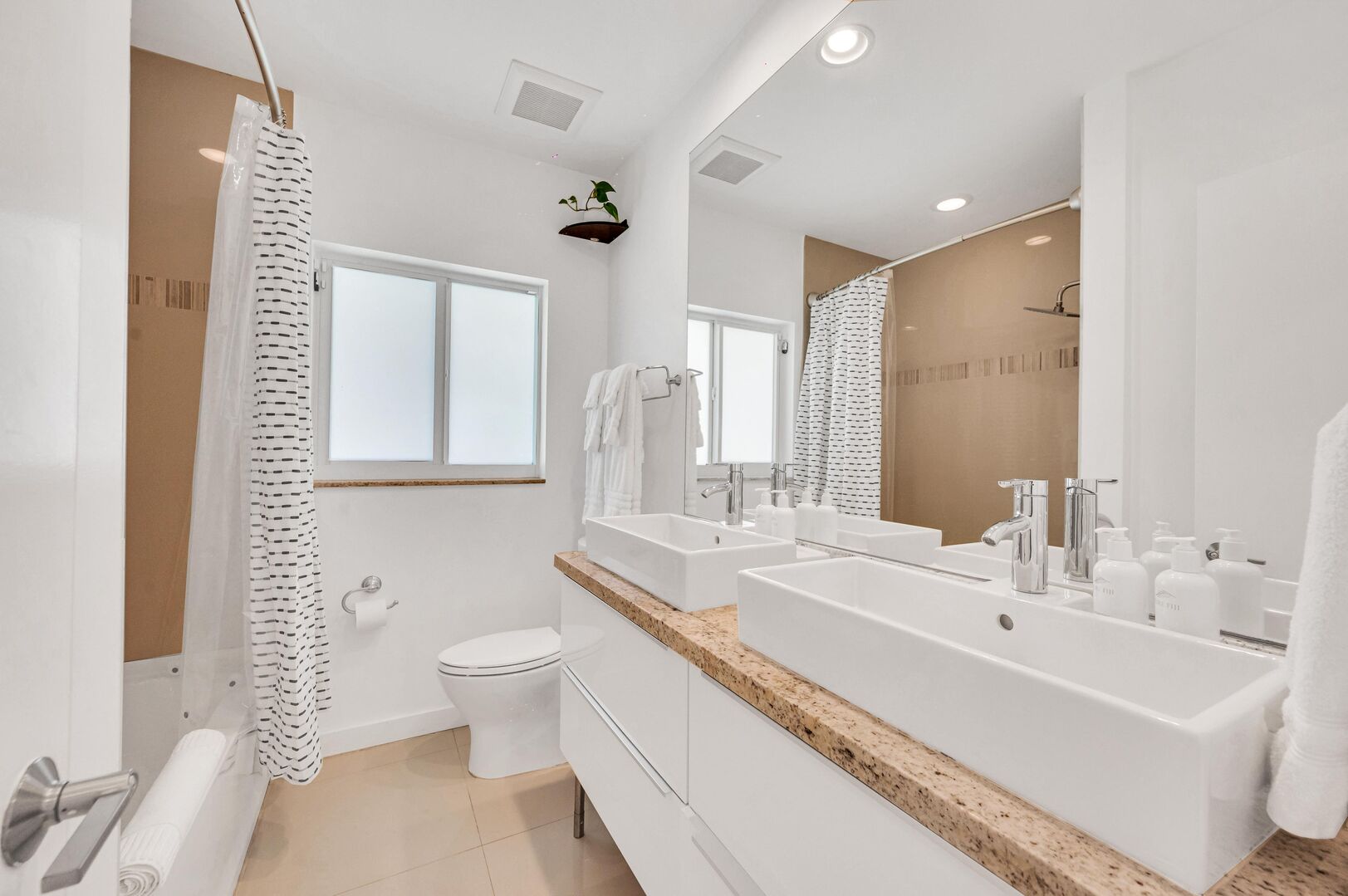 Guests' Oasis of Luxury: Immerse Yourself in Comfort in Our Guest Bathroom, Complete with Double Vanity, Shower/Tub, and Lavish Luxury Soaps. Your Haven of Indulgence Awaits.