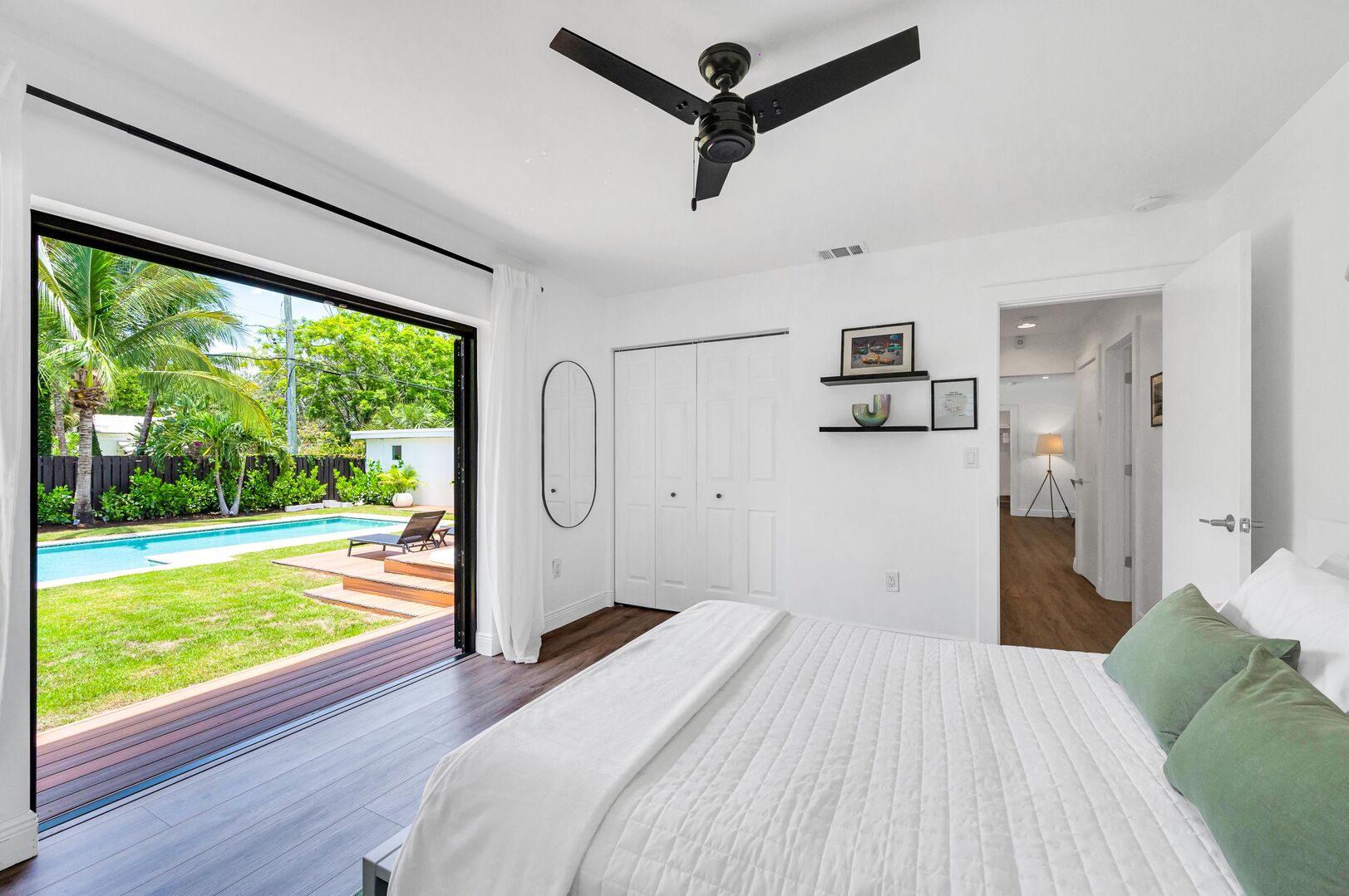 Unwind in Our Guest Bedroom, Offering a Queen-Size Bed, Smart TV, and Direct Doors Leading to the Pool. Your Perfect Blend of Comfort and Outdoor Delight.