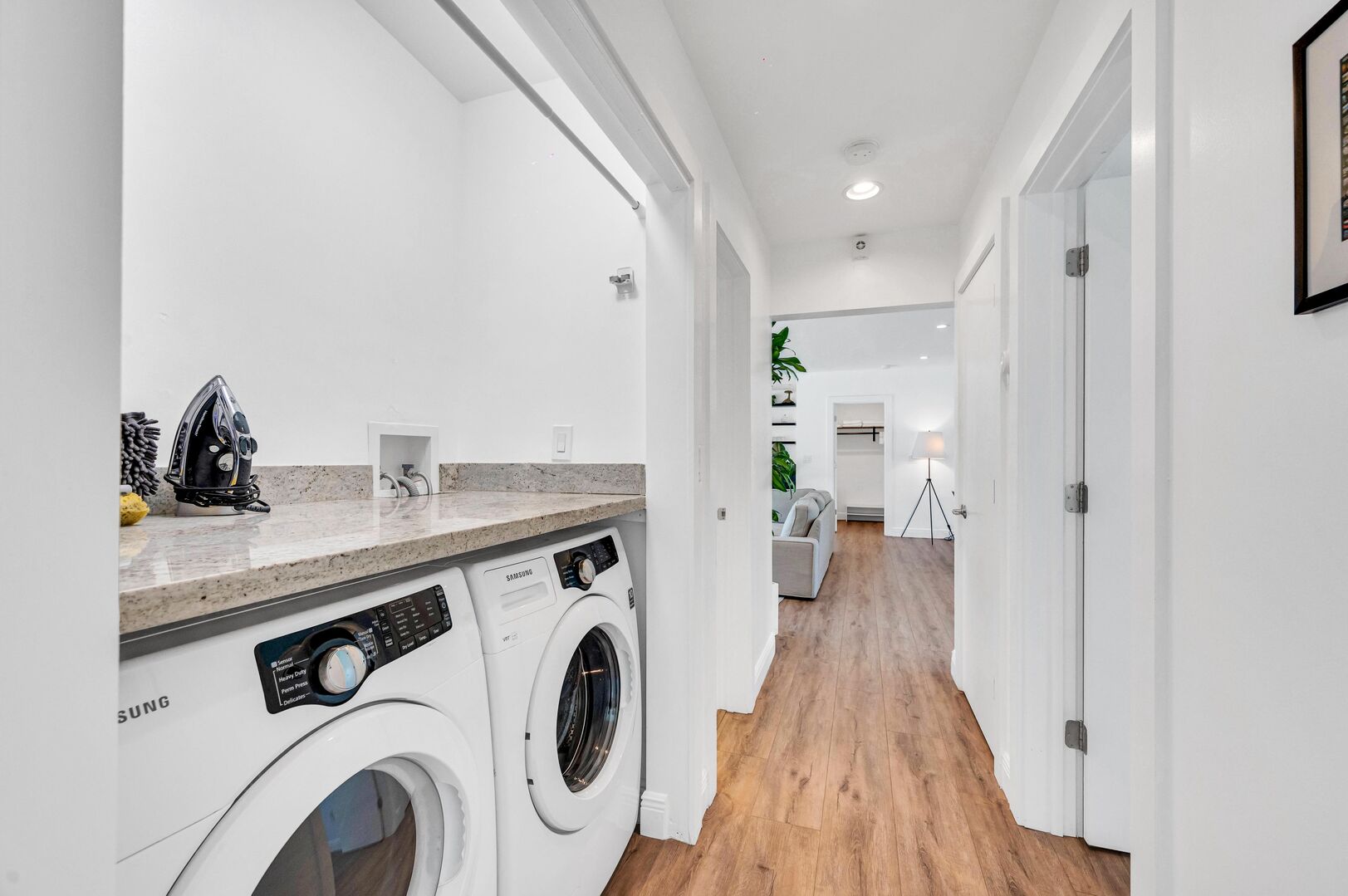 Convenience at Your Fingertips: Discover Effortless Living with a Hallway Laundry Room, Complete with All the Essentials, Including Tide Pods. Your Travel with Ease Experience Begins Here.