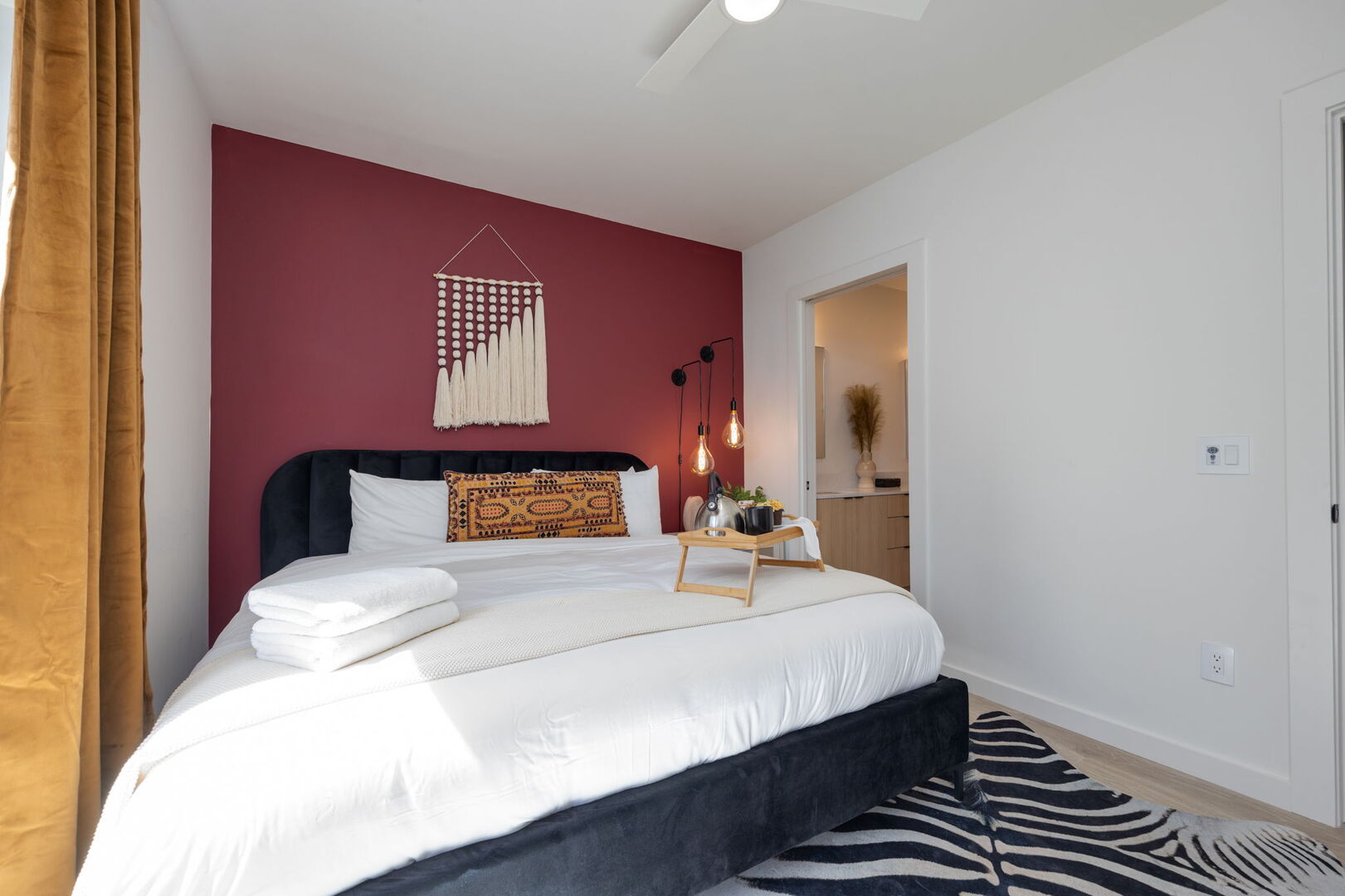 Primary bedroom with King bed, designer furnishings with shower/tub combo, double vanity and walk-in closet.