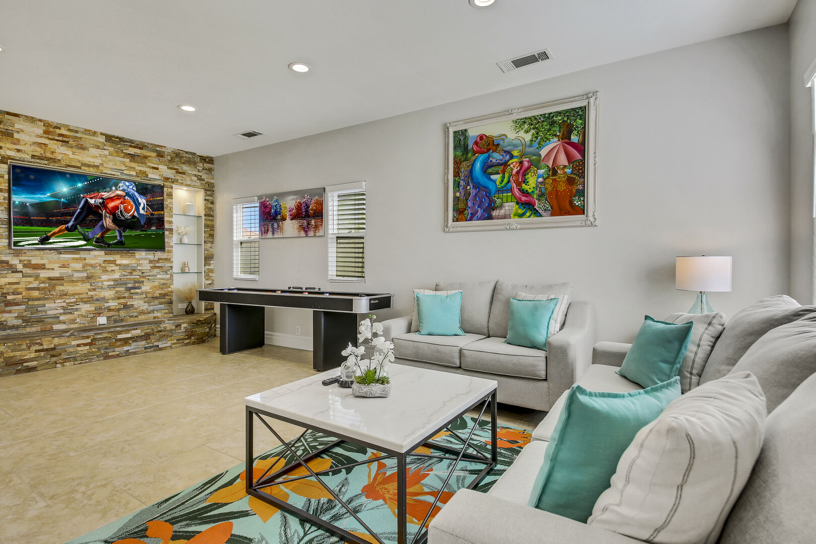 The family room provides ample space for relaxation in front of a 70-inch Samsung 4K Smart television.