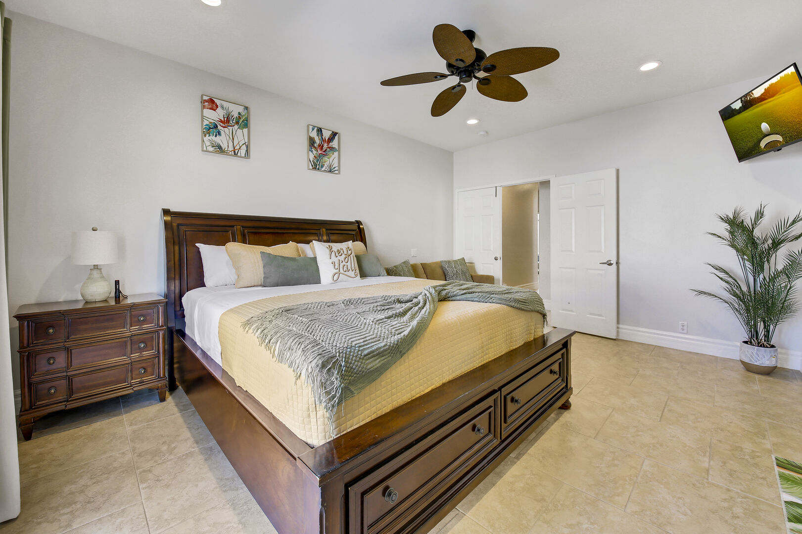 Master Suite 1 is located at the end of the hallway next to bedroom two and features a King-sized Bed, a Full-sized Sofa Sleeper, a 43-inch Insignia Smart television, a remote-controlled ceiling fan, and a walk-in closet.