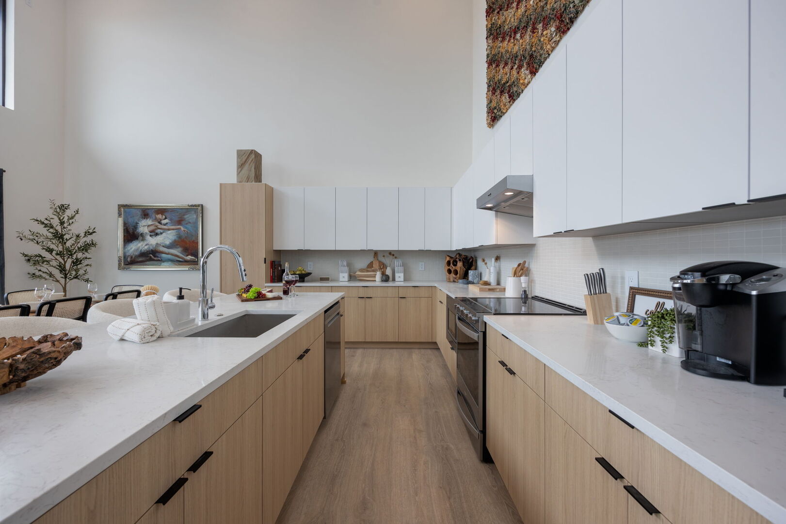 Main Level: Fully equipped kitchen with stainless-steel appliances and essential supplies, complemented by a bar seating for 4, seamlessly connecting to the spacious dining area for a perfect blend of functionality and style.