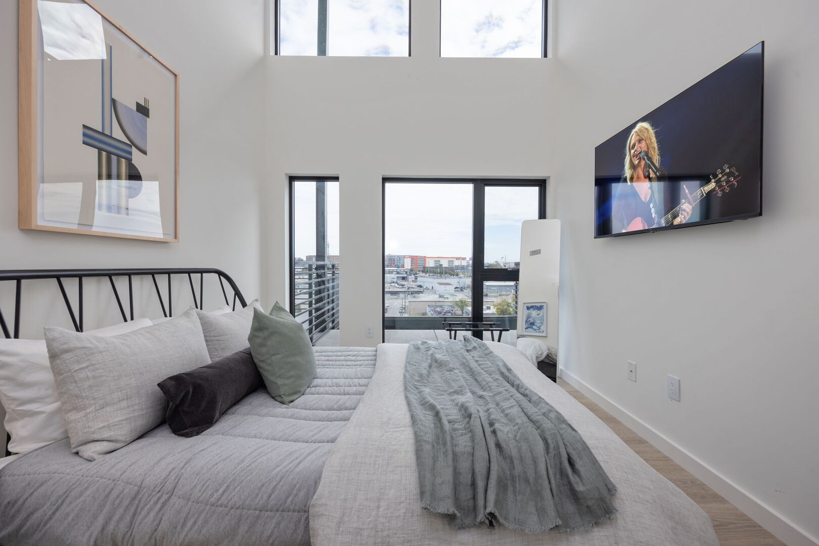 Main Level: 3rd bedroom with Queen bed, en-suite bathroom, smart TV, and designer furnishings.