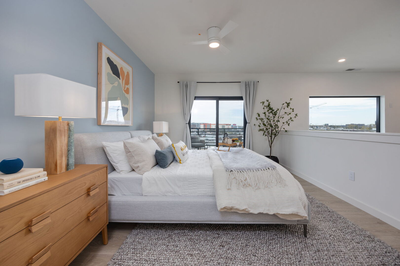 Upper Level: Primary bedroom with King bed, en-suite bathroom, walk-in closet, and its very own private balcony. The bedroom overlooks the living area.