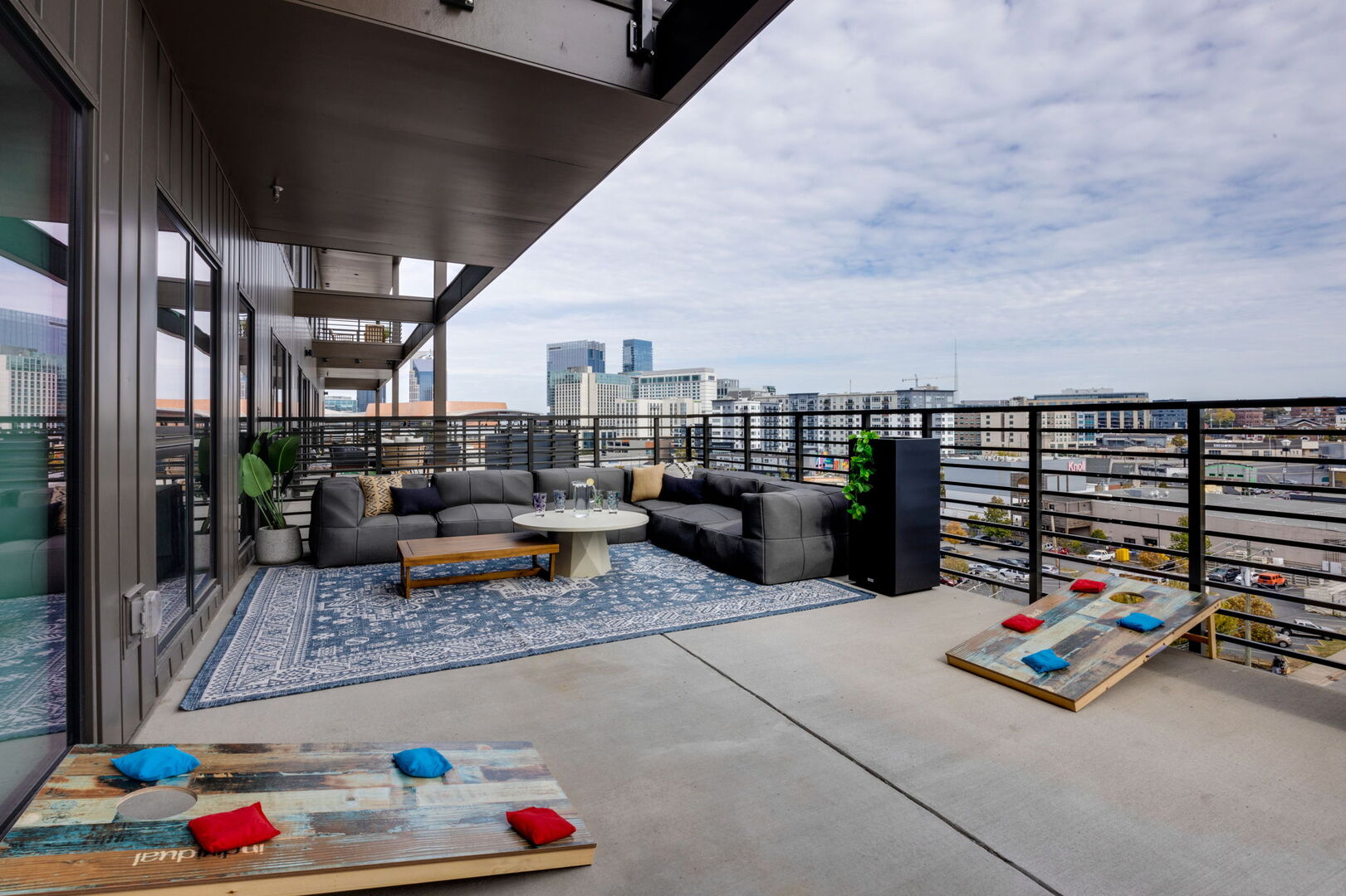 Main Level: Large private patio with a large lounge area, cornhole, giant Jenga, and additional seating overlooking the Nashville skyline.