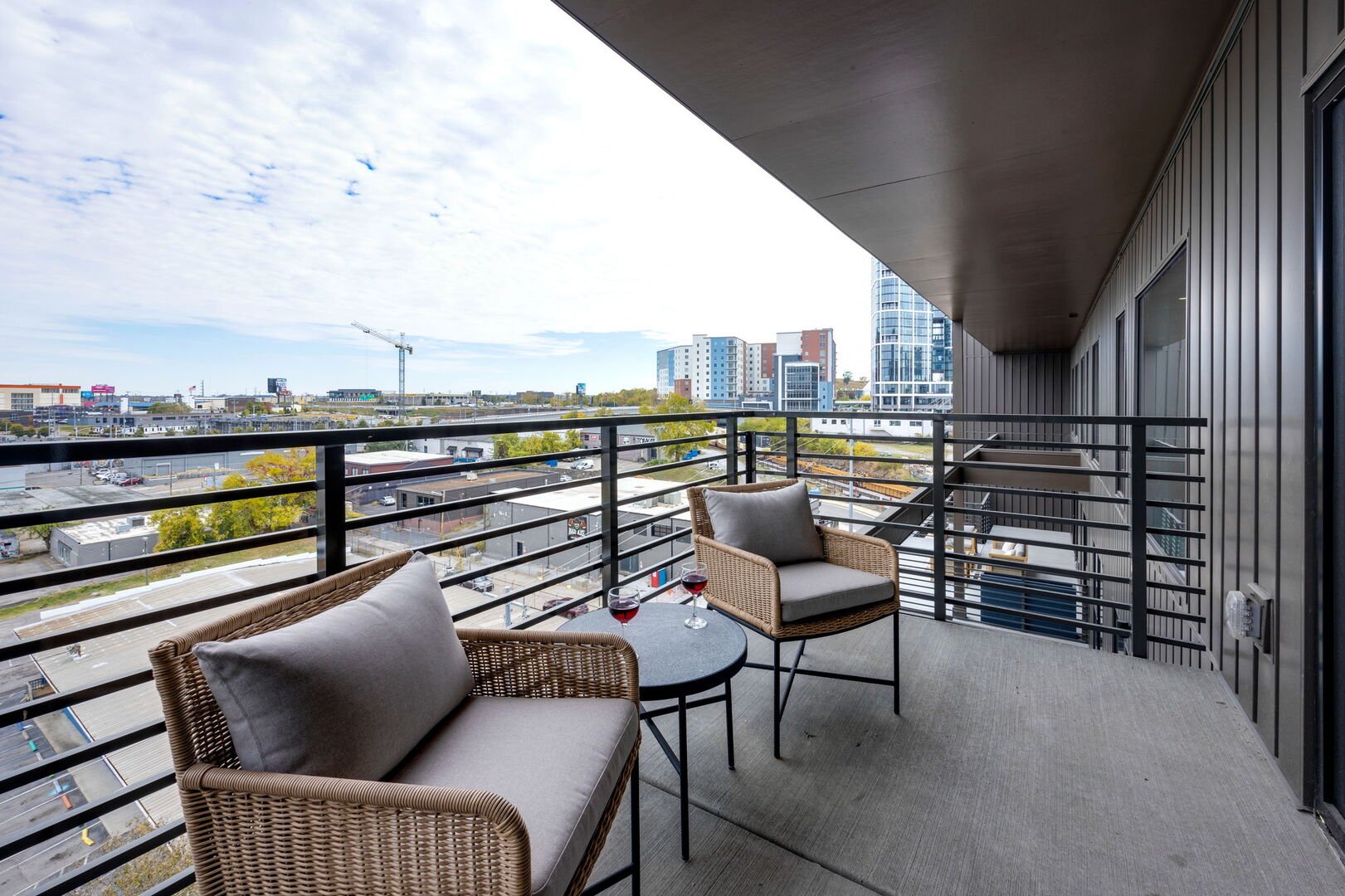 Upper Level: Primary bedroom with its own private balcony overlooking the Nashville skyline.