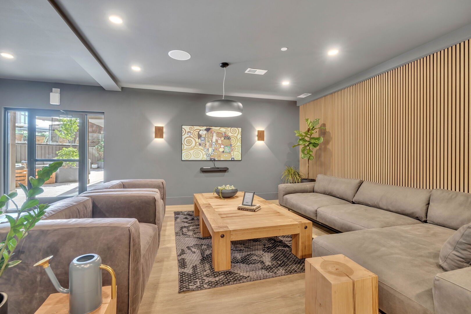 Communal Area: Modern lobby lounge featuring a kitchenette, electric fireplace, and multiple hangout areas.