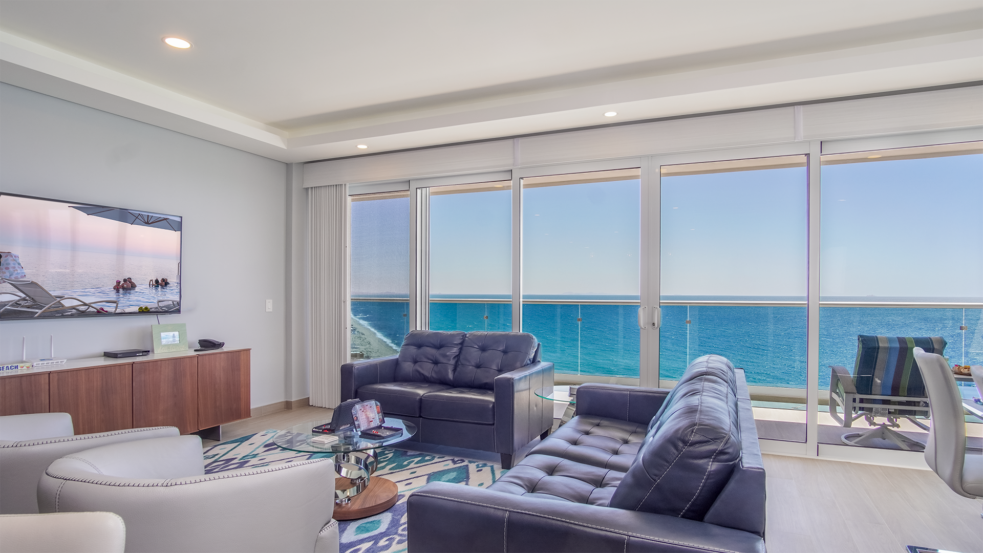 Beautiful ocean views from the living room with its comfy leather sofas, and stylish barrel chairs.