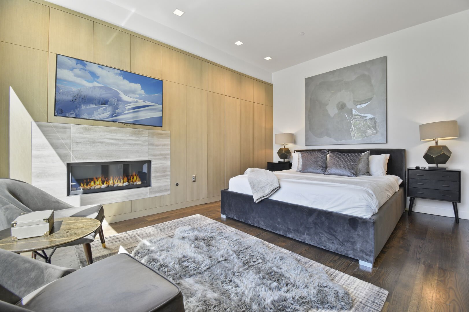 Master suite on the main level with a king bed and fireplace.