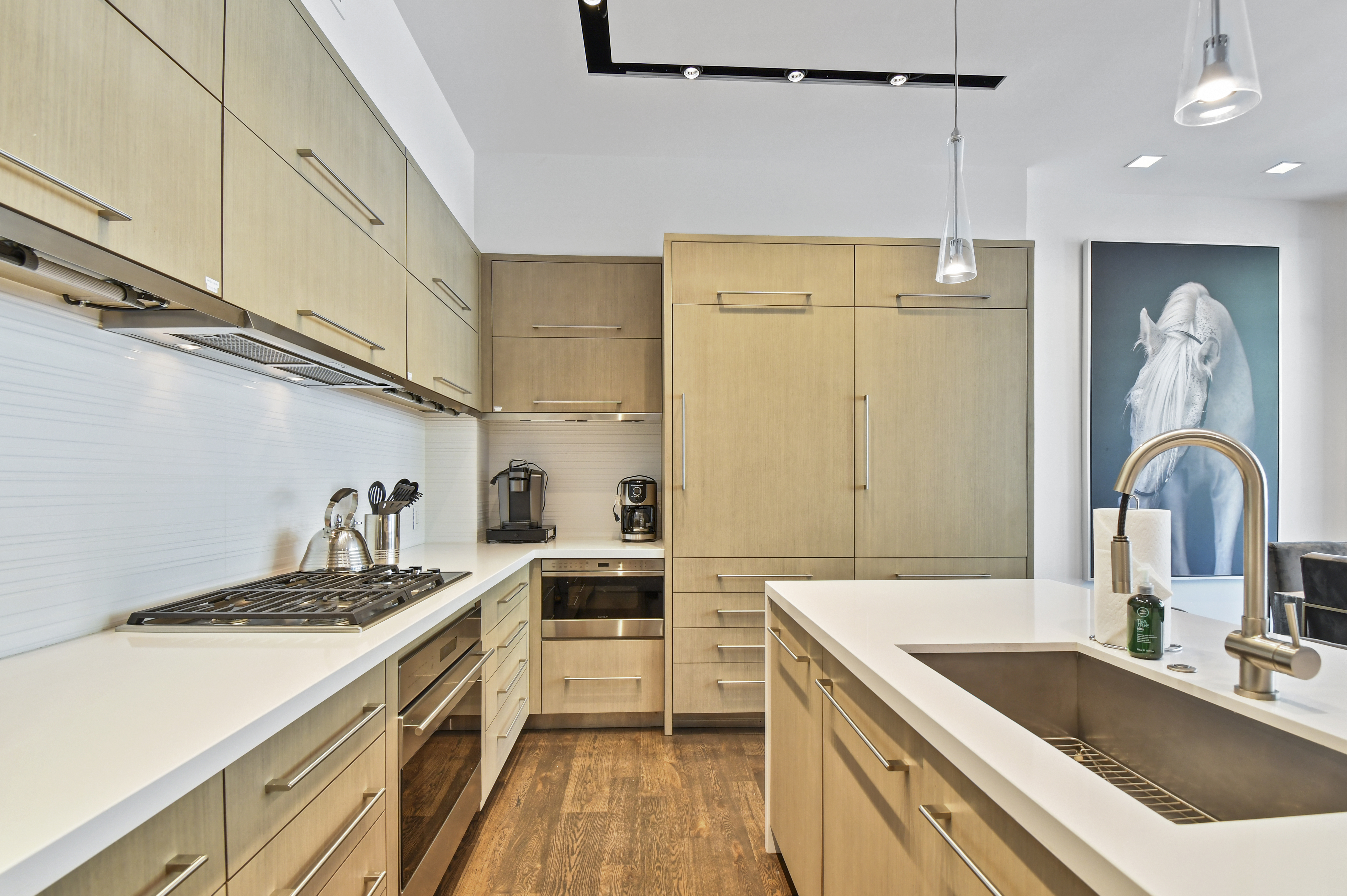 Sleek and modern finishes in the fully stocked kitchen.